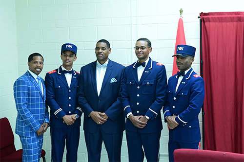 FOI standing in front of Flag of Islam at NOI Mosque