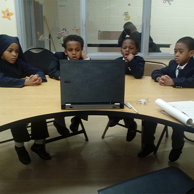 Nation of Islam students watching laptop in school
